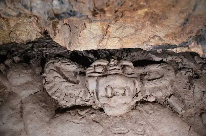 High-relief male figure wearing a full feline mask and headdress. Credit: Leslie F. Zubieta Calvert / INAH