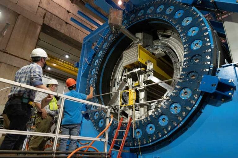 The sPHENIX detector is the newest experiment at Brookhaven National Laboratory’s Relativistic Heavy Ion Collider (RHIC) and is designed to precisely measure products of high-speed particle collisions. This image shows the installation of the inner hadronic calorimeter within the core of the sPHENIX superconducting solenoid magnet. Credit: Courtesy of Brookhaven National Laboratory