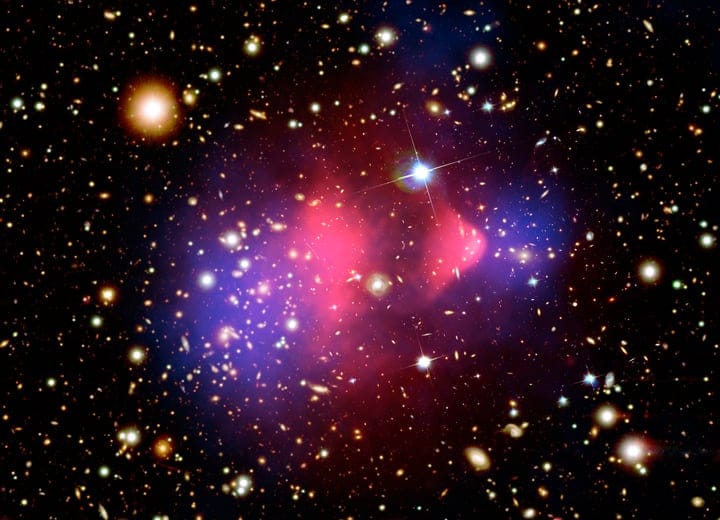 The Bullet Cluster, where two galaxy clusters have collided and the mass has separated from the visible matter. The blue regions are dark matter, the substance this entire solution depends on, and which nobody has yet identified (Credit : X-ray NASA/CXC/CfA/M. Markevitch et al.; Optical NASA/STScI; Magellan/U.Arizona/D. Clowe et al.; Lensing map NASA/STScI; ESO WFI; Magellan/U.Arizona/D. Clowe et al.)