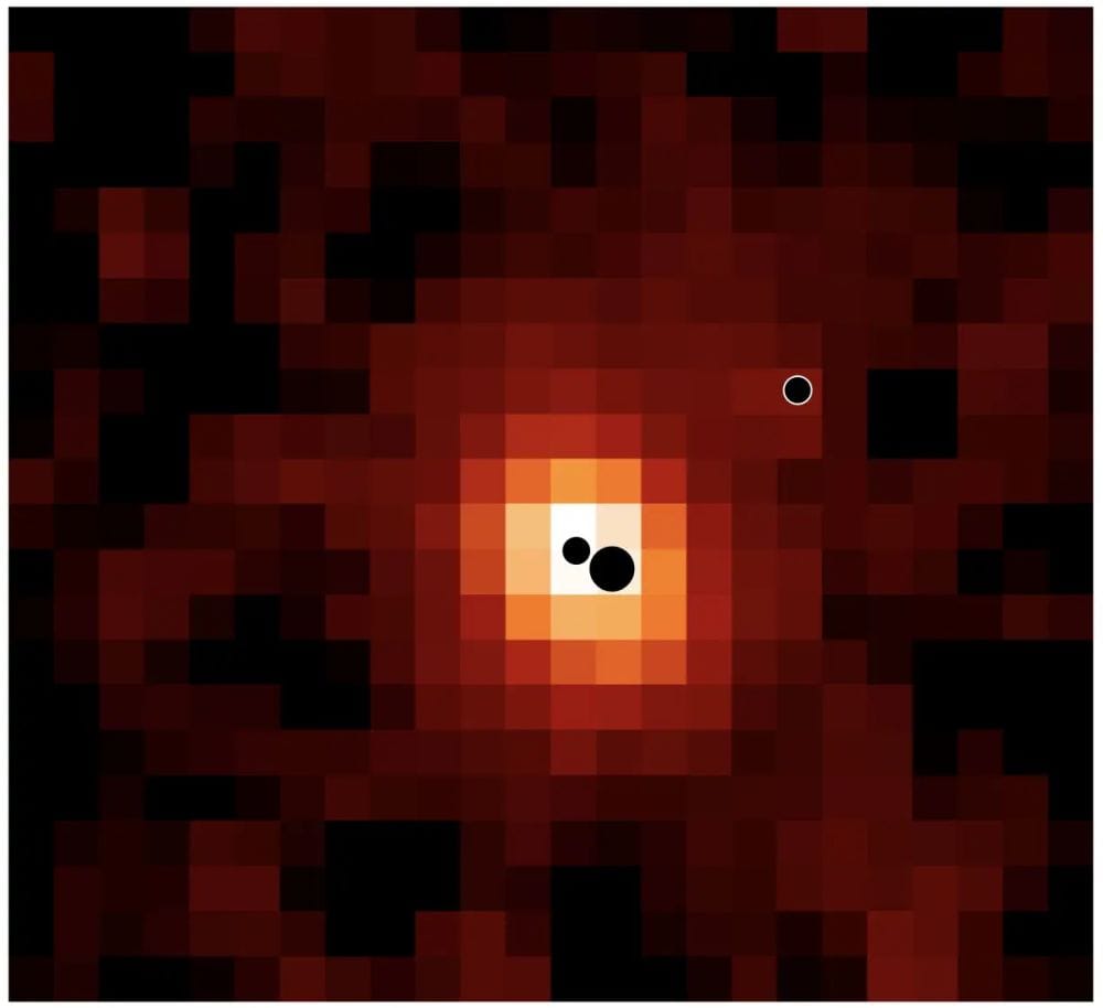 This is an ionized hydrogen map of J0148-4214 from the JWST. The three black circles are the black holes (not to scale). The most and least massive BH are closest together and should merge in about 700 million years. The more distant one is destined for a later merger. Image Credit: Hannah Übler