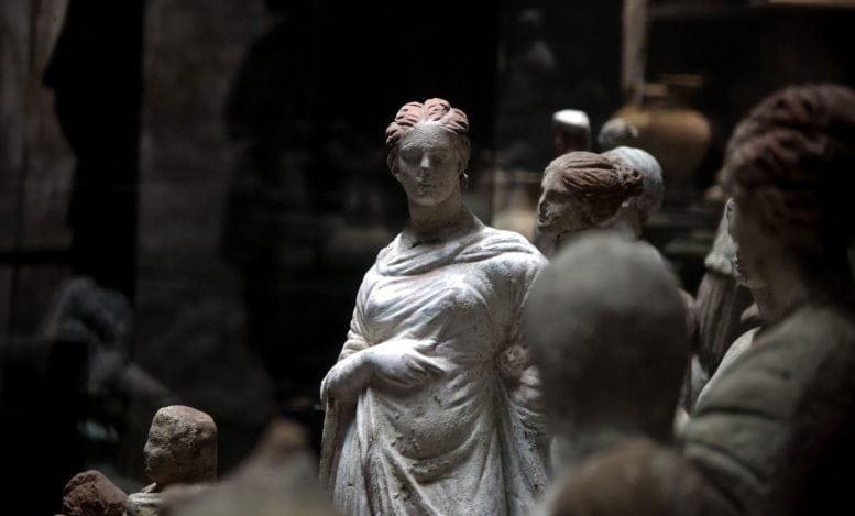 Collection of Ancient Roman Statues Displayed in a Dark Museum Setting.