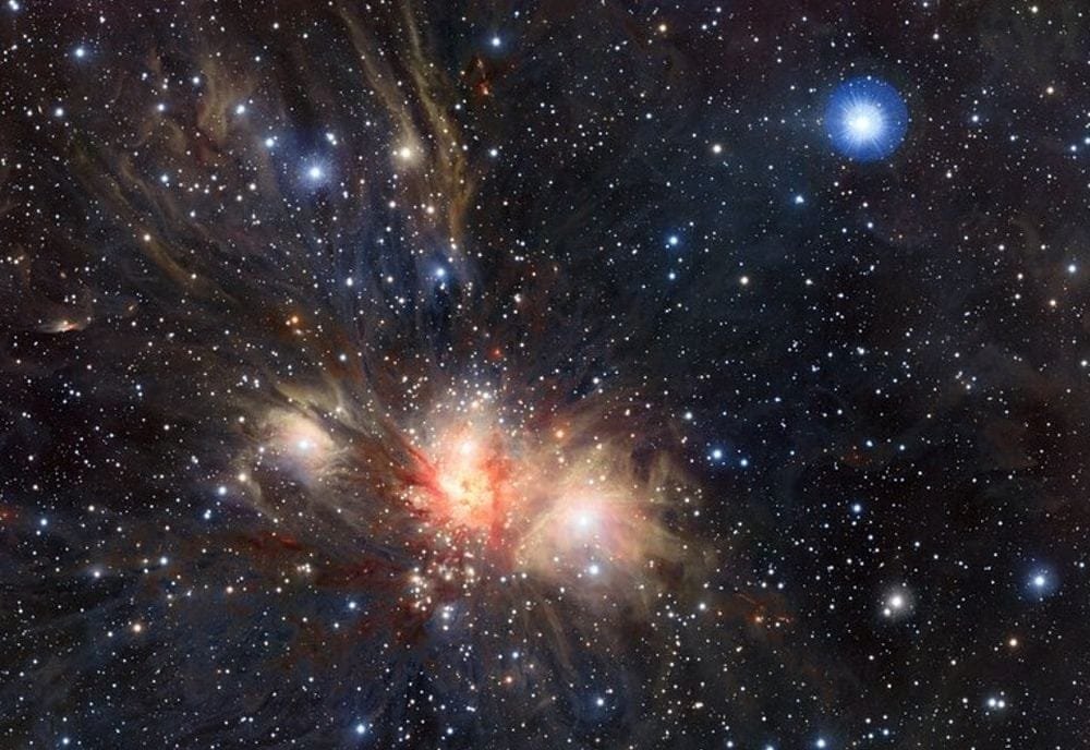 The ESO's VISTA telescope captured this infrared image of the Monoceros R2 star forming region. It's about 2,700 light years away, and is mostly an illuminated cloud of molecular hydrogen, the star-forming gas. It's undergoing a wave of star formation, and astronomers have mapped how the gas moves around in filaments and interfilaments into star forming hubs. Image Credit: ESO/J. Emerson/VISTA. Acknowledgment: Cambridge Astronomical Survey Unit