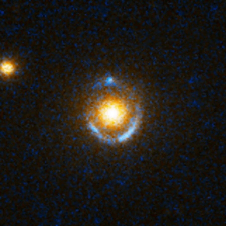 The blue rings are distant galaxies smeared into circles by the mass of the reddish elliptical galaxies in front of them (Credit : NASA/ESA/SLACS Survey Team: A. Bolton (Harvard/Smithsonian), S. Burles (MIT), L. Koopmans (Kapteyn), T. Treu (UCSB), L. Moustakas (JPL/Caltech))