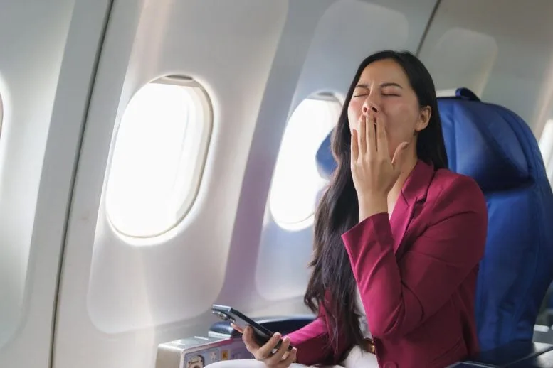 Tired Businesswoman Yawning Airplane Flight