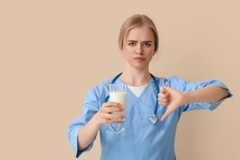 Female Doctor Glass of Milk Thumbs Down