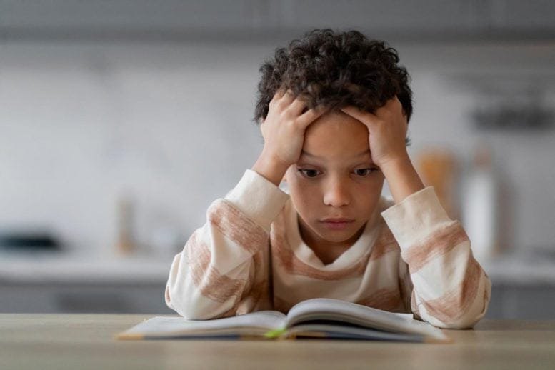 Stressed Little Boy Reading Book