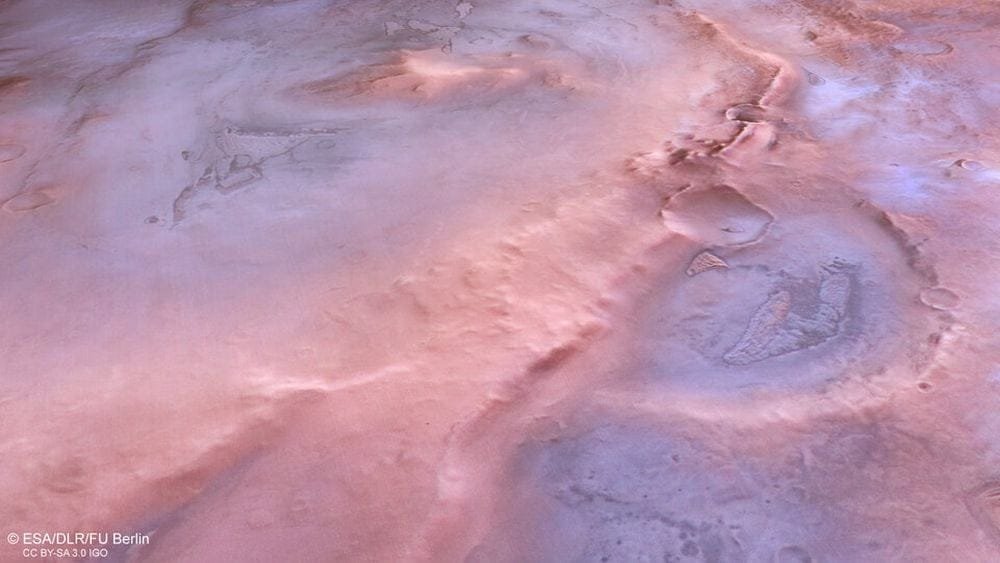 This image shows Thyles Rupes from directly above. It sits above some craters and under others, with older ones being under it. The crater on the right, the largest in the image, is older than Thyles Rupes and has been cut in half by it. Two smaller craters are visible, and they're from impacts that happened after the feature formed. Image Credit: ESA/DLR/FU Berlin. Licence: ESA Standard Licence