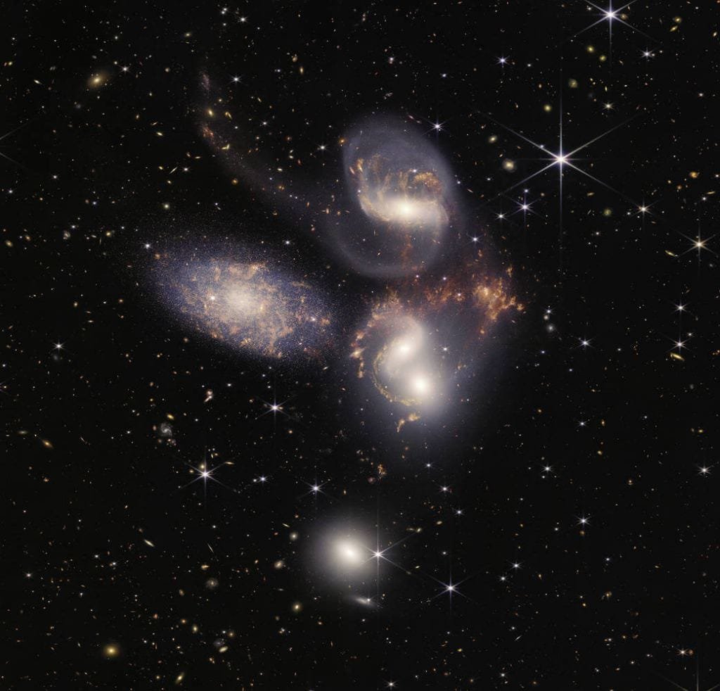 This JWST mosaic of Stephan's Quintet is a composite of almost 1,000 images. While it's a visual quintet, only four of them are in the same compact group. Astronomers recently created a high-resolution map of the movement of star-forming gas in the group. Image Credit: NASA, ESA, CSA, STScI