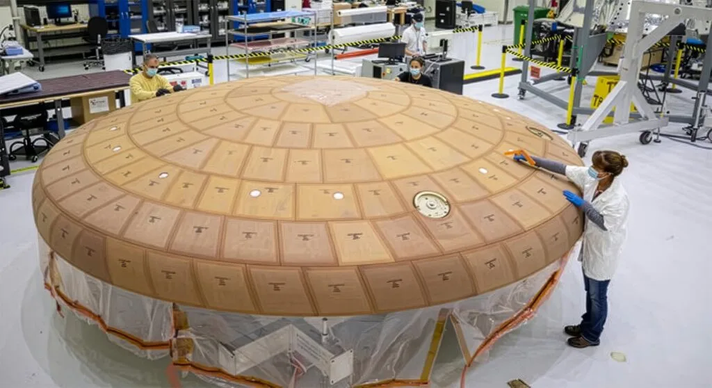 Engineers working on the Artemis II heat shield at the Kennedy Space Center. Credit - NASA