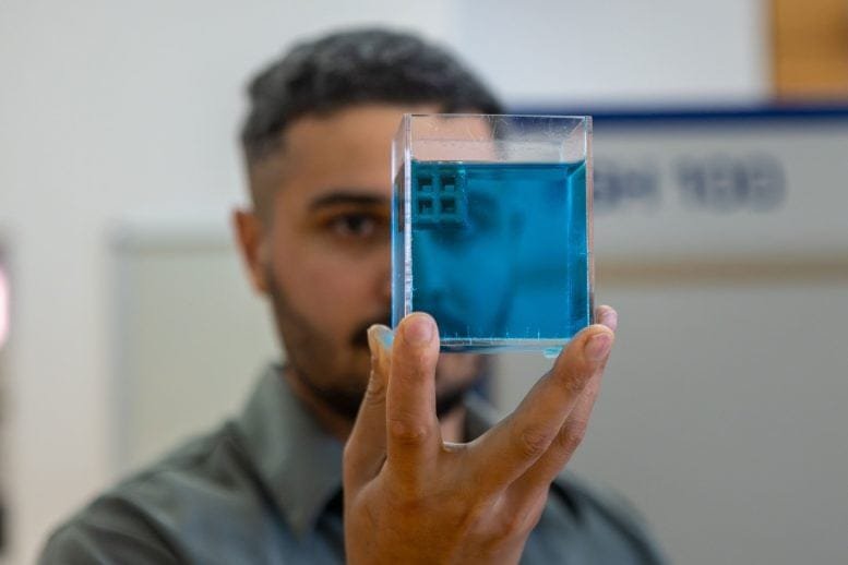 Jordan Noronha Holding a Sample of a Floating Titanium