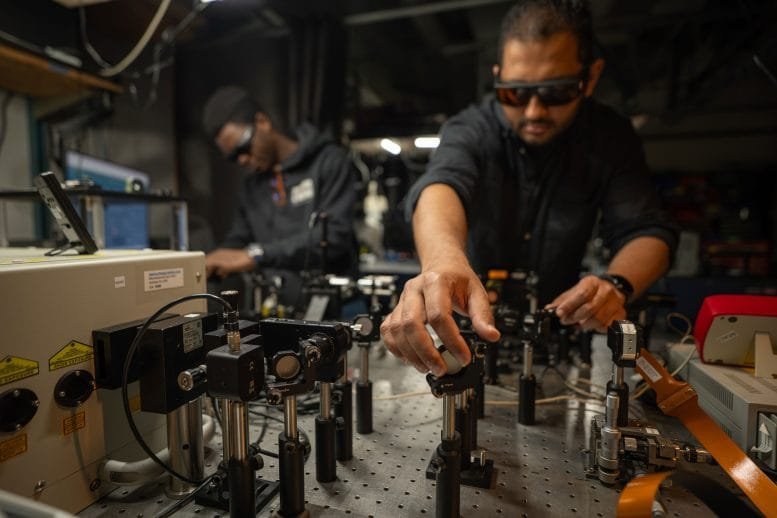 Muhammad Waleed Khalid and Koffi Sadzi Work at Optical Bench