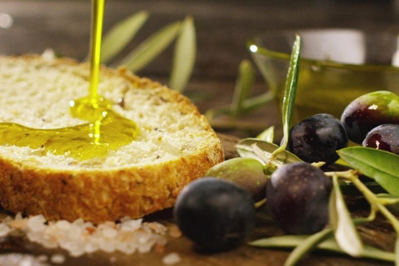 Organic Olive Oil Pouring Onto Bread
