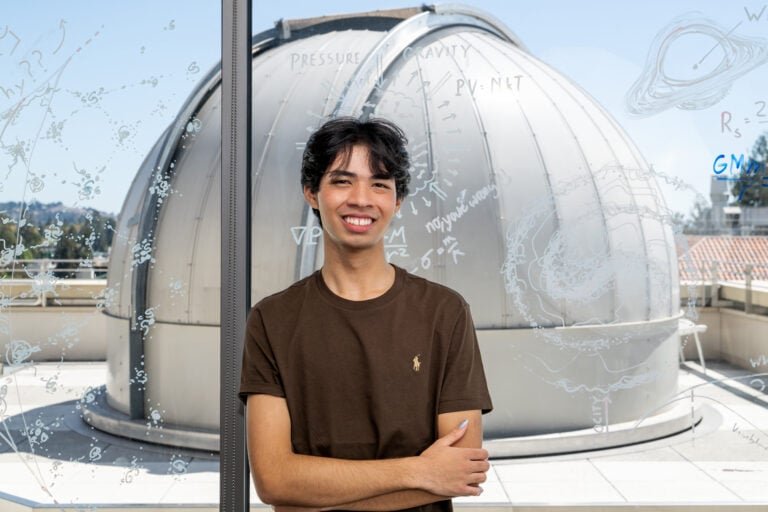 Julian Shapiro poses in front of the Richard Treffers Telescope on the rooftop of UC Berkeley's Campbell Hall.Credit: Shannon Kelli