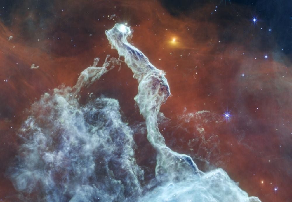 The white colour of the gas in this mid-infrared JWST image makes it look like Earthly clouds. Fewer stars are visible in the background, their light blocked out by the gas, which appears thicker. In the gas to the left, finer detail is visible in the gas clouds. Image Credit: NASA, ESA, CSA, STScI. Image Processing: J. Depasquale (STScI).
